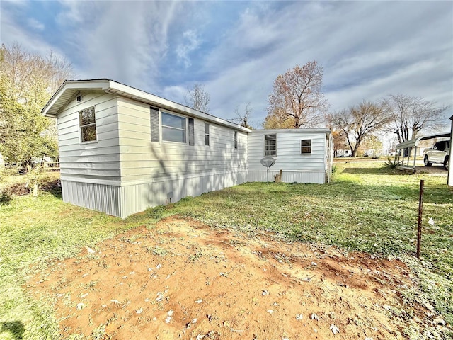 view of side of property with a lawn