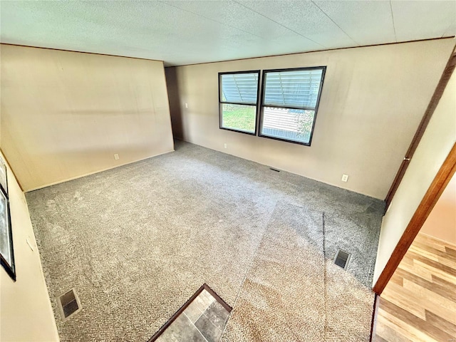 empty room featuring hardwood / wood-style floors and a textured ceiling