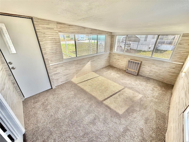 unfurnished sunroom with lofted ceiling