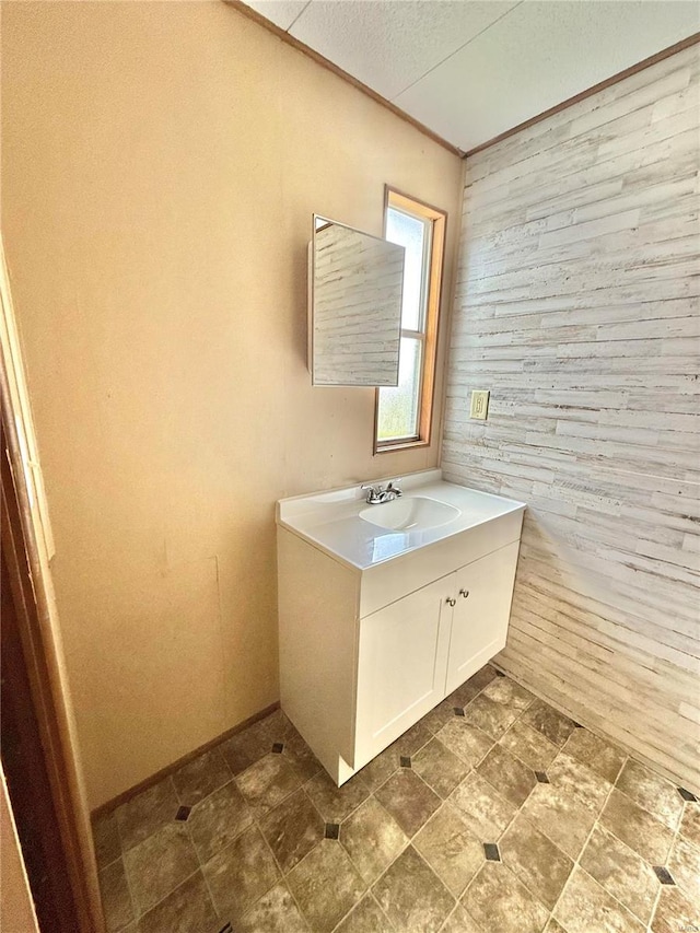 bathroom featuring vanity and wooden walls