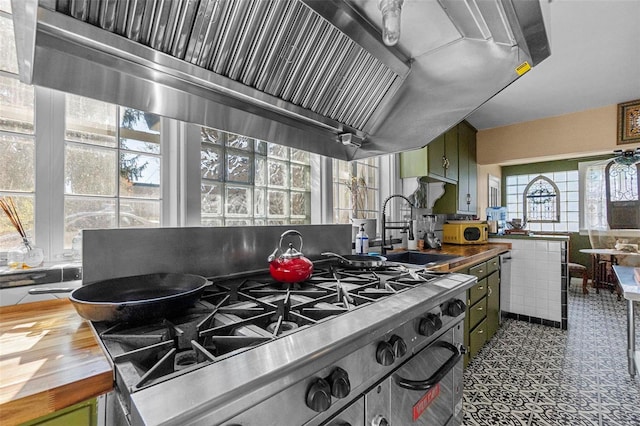 kitchen featuring wood counters, hardwood / wood-style flooring, green cabinets, and sink