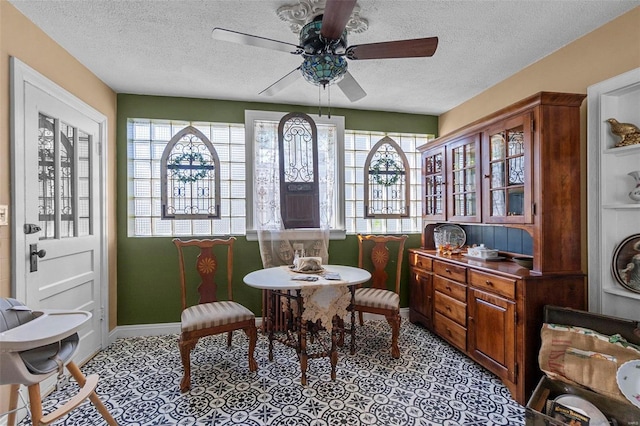 dining room featuring a healthy amount of sunlight and a textured ceiling