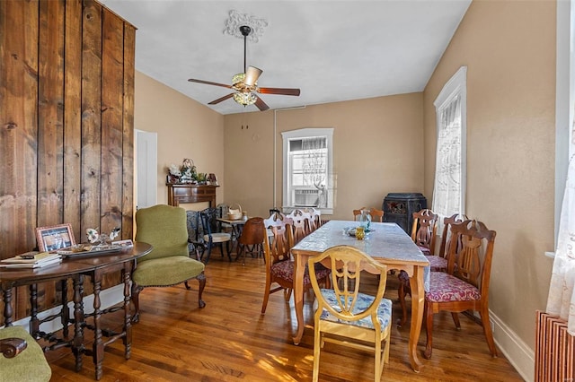 dining room with hardwood / wood-style flooring, ceiling fan, and lofted ceiling