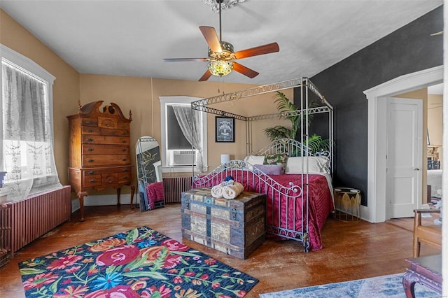 bedroom with radiator, ceiling fan, hardwood / wood-style floors, and cooling unit