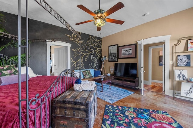 bedroom featuring ceiling fan and hardwood / wood-style flooring