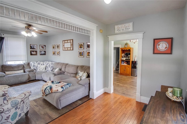 living room featuring light hardwood / wood-style floors and ceiling fan