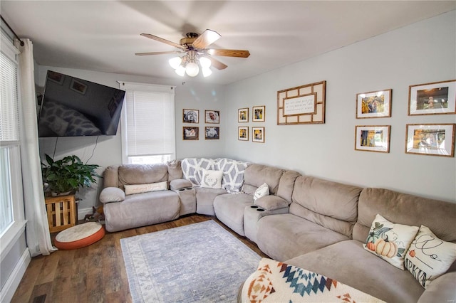 living room featuring wood-type flooring and ceiling fan