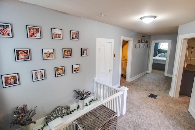 hallway with light carpet