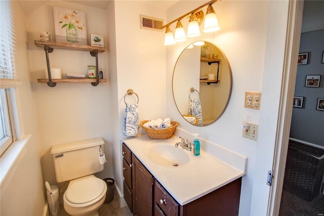 bathroom with vanity and toilet