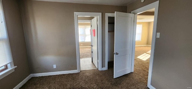 unfurnished bedroom with dark carpet