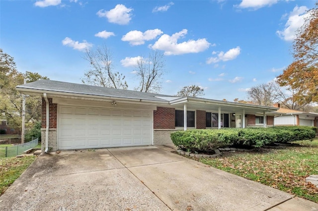 ranch-style home featuring a garage and covered porch