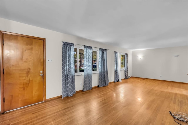 empty room with light hardwood / wood-style floors