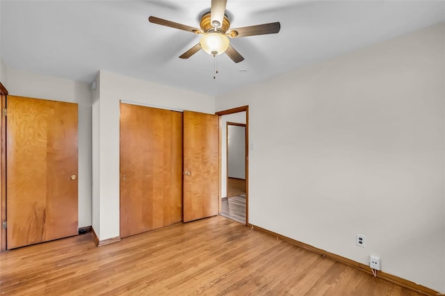 unfurnished bedroom featuring ceiling fan, a closet, and light hardwood / wood-style flooring