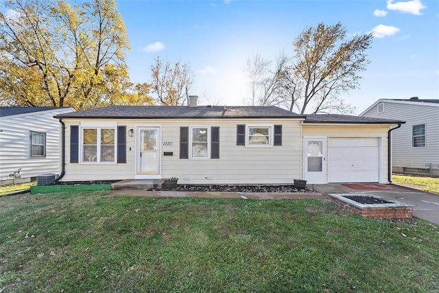 ranch-style home with a garage and a front lawn