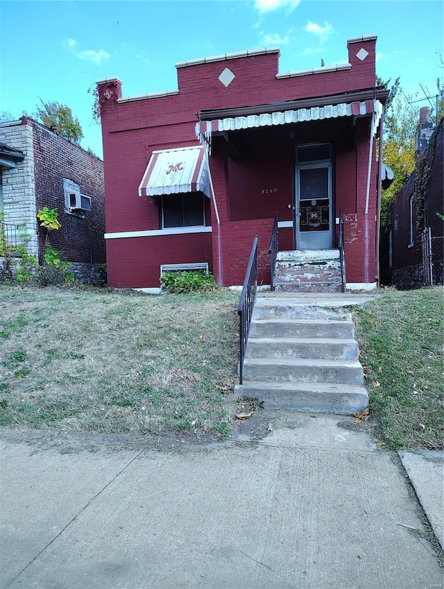 bungalow-style home with a front lawn