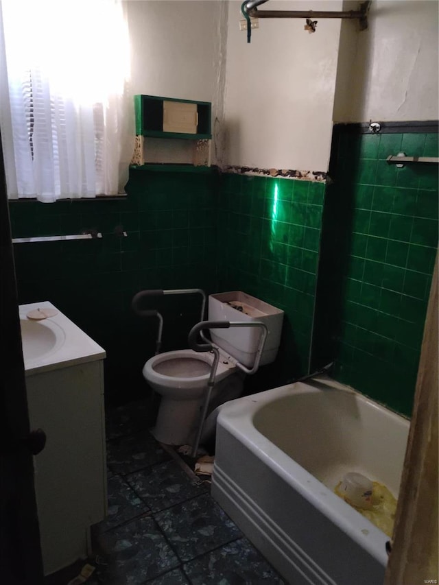 bathroom featuring toilet, tile walls, a tub, and tile patterned flooring