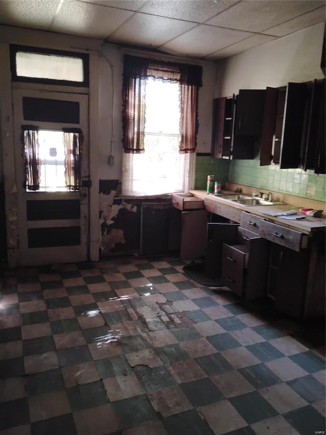 kitchen with sink, backsplash, and a drop ceiling