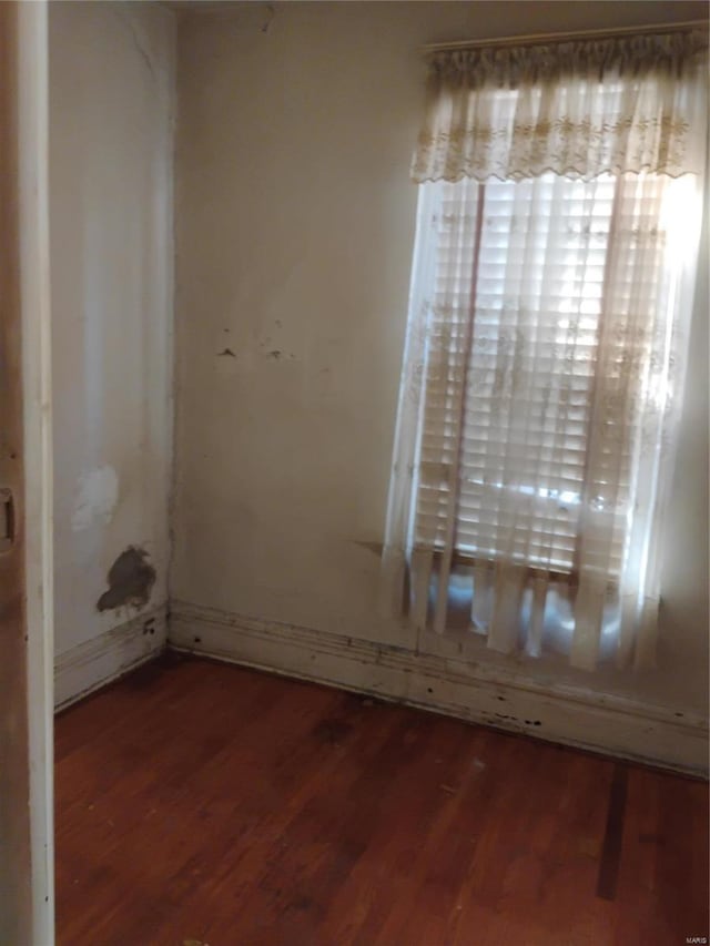 empty room with dark wood-type flooring