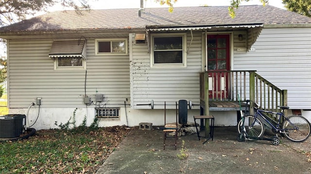 rear view of house featuring central AC