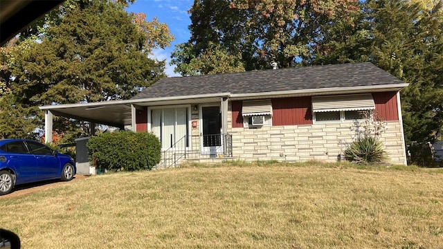 view of front of property with a carport and a front lawn