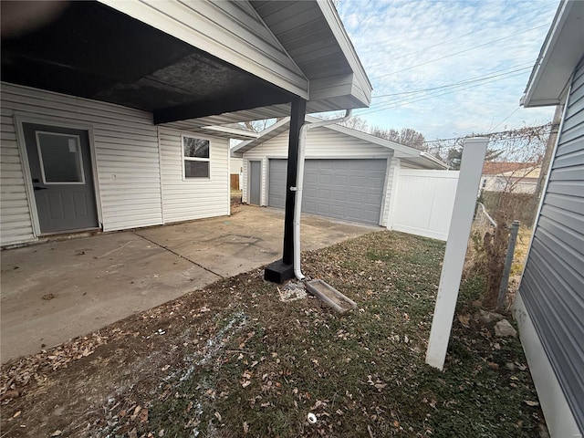 view of patio / terrace with an outbuilding and a garage