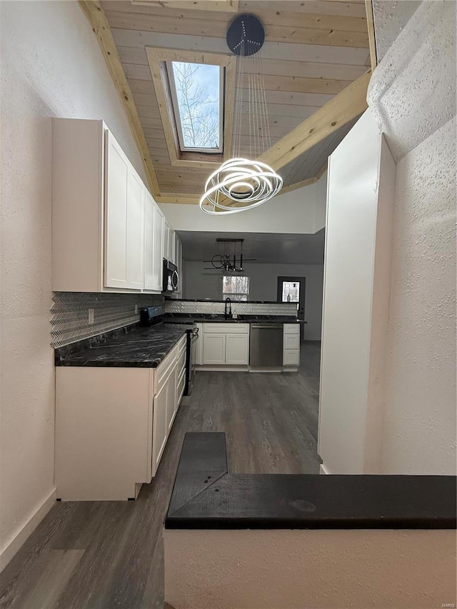 kitchen with white cabinetry, stainless steel appliances, wooden ceiling, dark hardwood / wood-style floors, and lofted ceiling with skylight