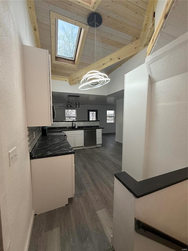 kitchen with wood ceiling, lofted ceiling with skylight, dark wood-type flooring, decorative light fixtures, and white cabinetry