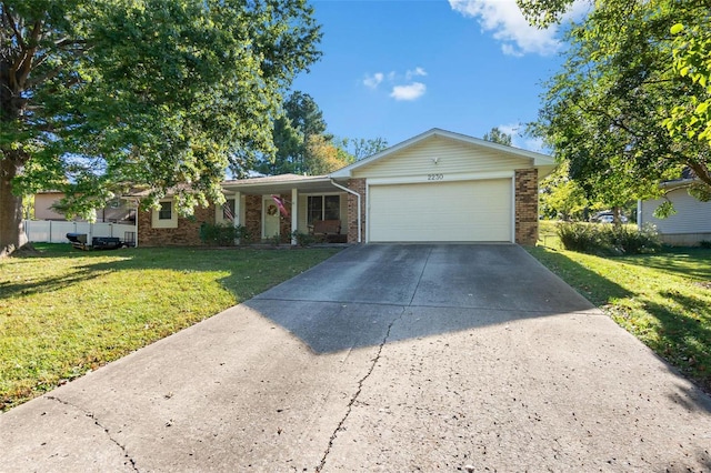 ranch-style house featuring a front lawn and a garage