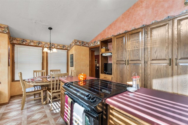 kitchen with a textured ceiling, a notable chandelier, black range with electric stovetop, pendant lighting, and vaulted ceiling