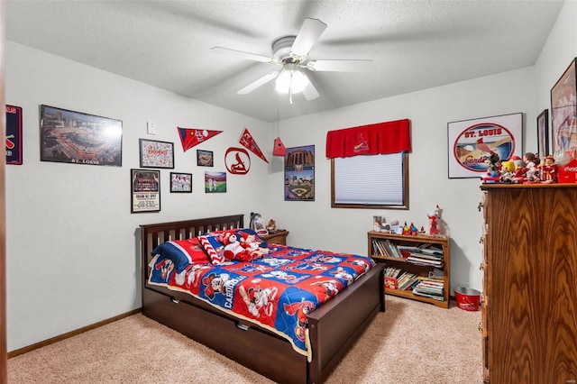 carpeted bedroom featuring a textured ceiling and ceiling fan