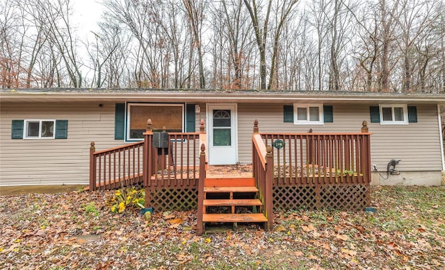 rear view of property featuring a deck