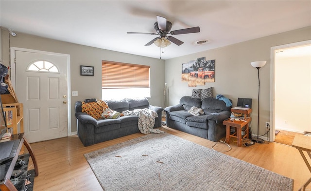 living room with ceiling fan, plenty of natural light, and light hardwood / wood-style floors