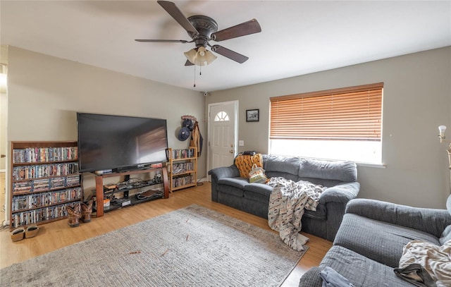 living room with light wood-type flooring and ceiling fan