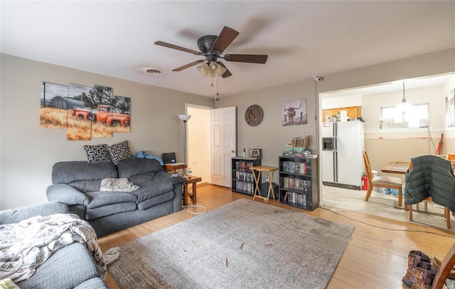 living room featuring ceiling fan and hardwood / wood-style flooring