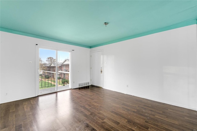 unfurnished room featuring dark wood-type flooring