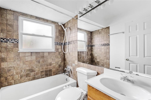 full bathroom featuring vanity, toilet, and tiled shower / bath combo