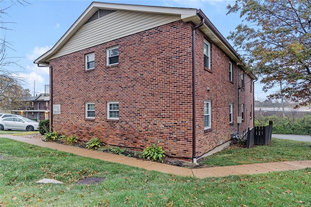 view of property exterior with a lawn