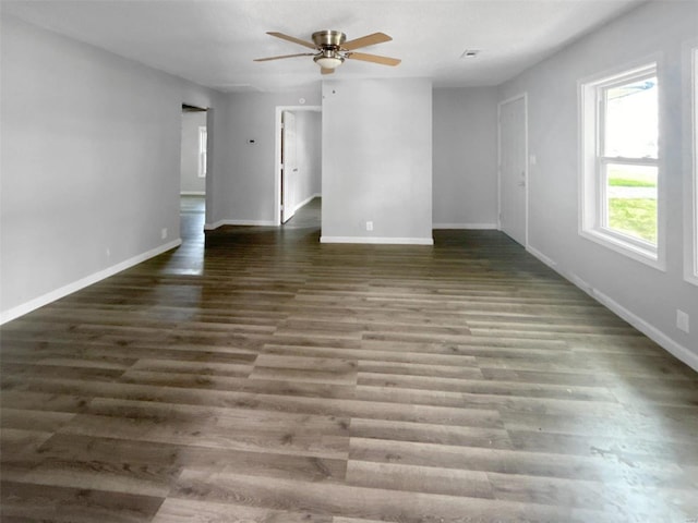 spare room featuring dark wood-type flooring and ceiling fan