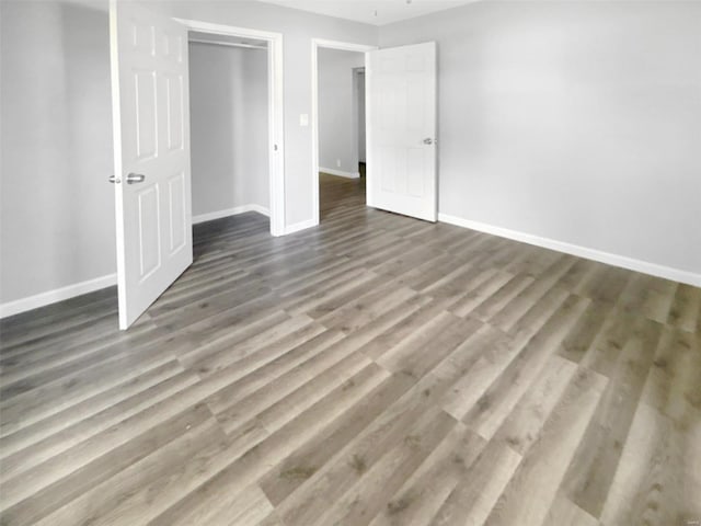 unfurnished bedroom featuring hardwood / wood-style floors and a closet