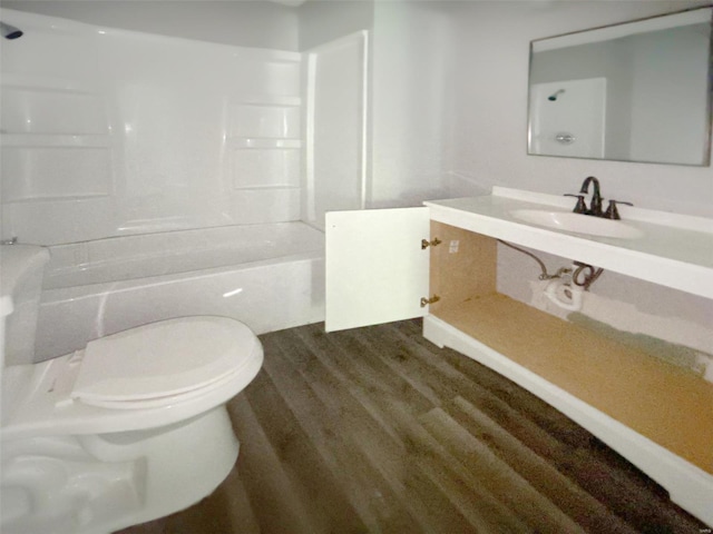 full bathroom featuring hardwood / wood-style flooring, toilet, shower / bath combination, and sink