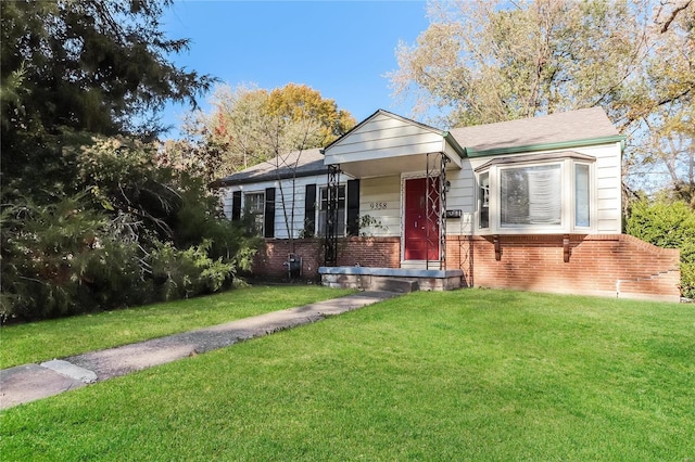 bungalow-style house with a front yard