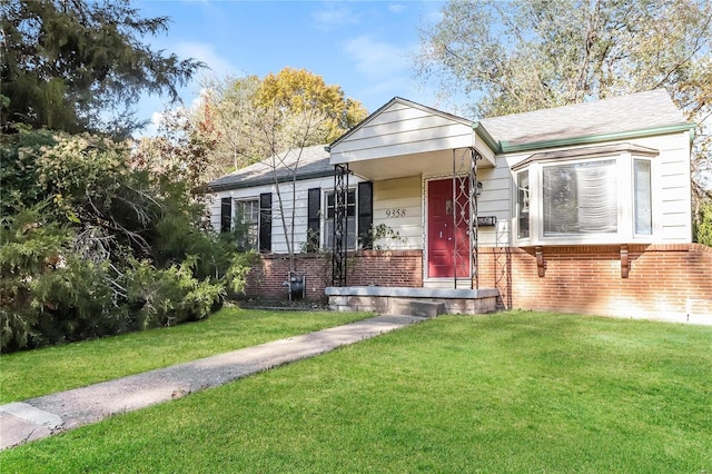 bungalow-style home with a front lawn