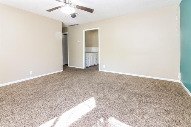 unfurnished bedroom with ensuite bath, carpet floors, and ceiling fan