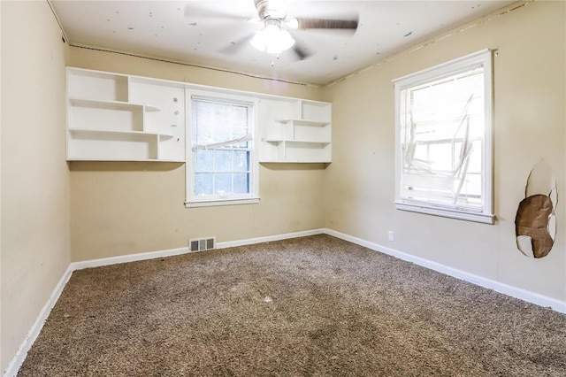 unfurnished room featuring ceiling fan, a healthy amount of sunlight, and carpet