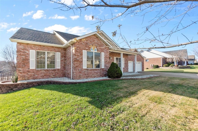 single story home featuring a garage and a front lawn