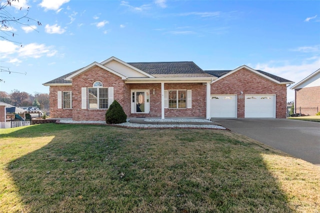 view of front of property featuring a garage and a front lawn