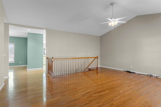 empty room featuring lofted ceiling, ceiling fan, and light hardwood / wood-style flooring