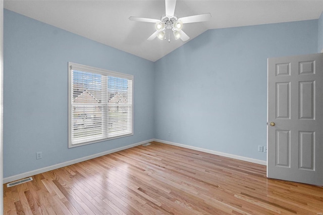 empty room featuring ceiling fan, lofted ceiling, and light wood-type flooring