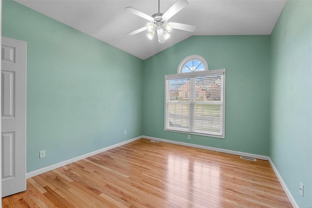 unfurnished room with ceiling fan, vaulted ceiling, and light wood-type flooring