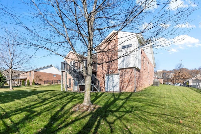 view of property exterior featuring central AC and a lawn